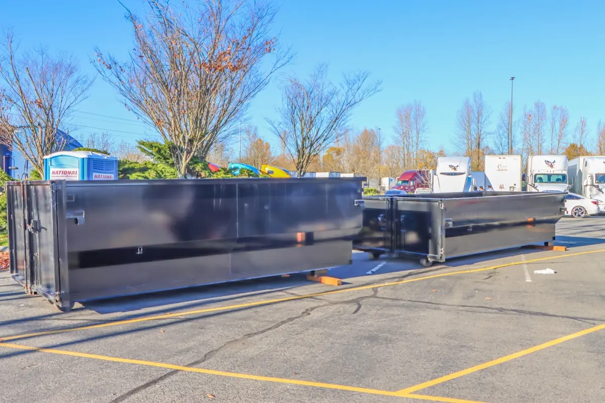 Professional dumpster rental service with roll-off container on residential driveway in Grove